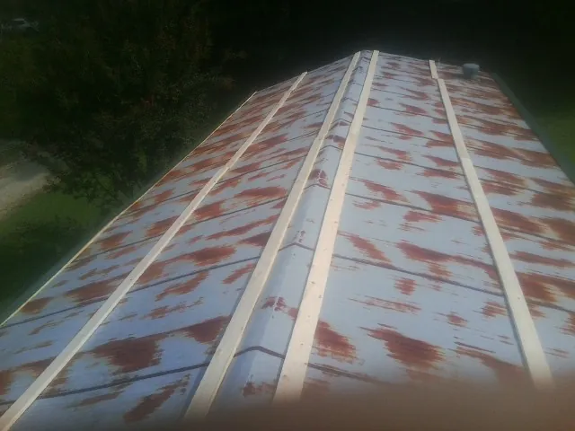 Rusted metal roof panels with new wood purlins before replacement — Storm Damage Roof Repair in Dousman by Roofing Brothers